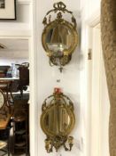 A PAIR OF VICTORIAN CARVED GILT AND GESSO TWO BRANCH GIRONDOLES WITH CIRCULAR BEVELLED MIRRORS
