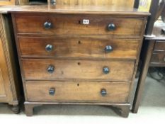 A LATE GEORGIAN MAHOGANY CHEST OF FIVE GRADUATING DRAWERS WITH EBONISED BUN HANDLES ON BRACKET FEET,