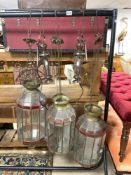THREE MOROCCAN GLASS LANTERNS, 60CMS APPROX, AND TWO SMALL BRONZE LANTERNS