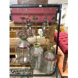 THREE MOROCCAN GLASS LANTERNS, 60CMS APPROX, AND TWO SMALL BRONZE LANTERNS