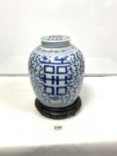 ANTIQUE CHINESE BLUE AND WHITE AND COVER, ON A CARVED BASE, 30CMS