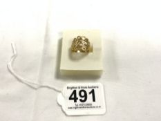 A YELLOW METAL PIERCED DRESS RING, TESTS AS GOLD, 4.1 GRAMS