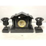 A VICTORIAN BLACK SLATE THREE-PIECE CLOCK GARNITURE WITH SIDE URNS BEING BRONZE RELIEF MOUNTED,