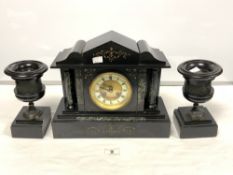 A VICTORIAN BLACK SLATE THREE-PIECE CLOCK GARNITURE WITH SIDE URNS BEING BRONZE RELIEF MOUNTED,