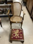 CANE SEAT AND BACK ELBOW CHAIR AND VICTORIAN MAHOGANY TAPESTRY FOOT STOOL