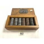 A QUANTITY OF MIXED METAL TOKENS, IN A PURPOSE-MADE OAK BOX, WITH AN EMBOSSED METAL PLAQUE OF MINING