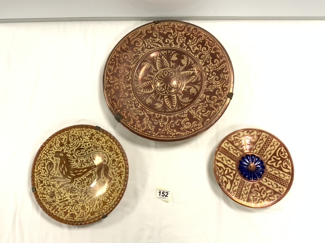 A COPPER LUSTRE CIRCULAR WALL PLAQUE, 39CMS, AND TWO SMALLER LUSTRE WALL PLATES