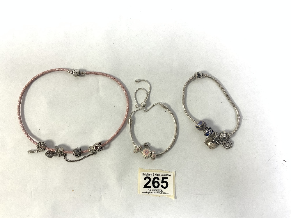 THREE PANDORA BRACELETS AND CHARMS