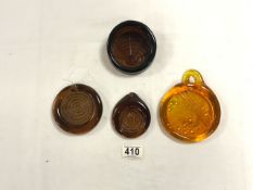 ERIC HOGLUND - FOUR BROWN GLASS EMBOSSED GLASS WEIGHTS