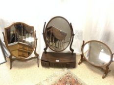 EDWARDIAN CROSSBANDED MAHOGANY BOW FRONT OVAL THREE DRAWER TOILET MIRROR WITH TWO SKELETON SWING