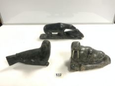 THREE INUIT HARDSTONE CARVINGS-A POLAR BEAR EATING A WALRUS WITH SIGNATURE TO BASE JOHNNY P 36CMS