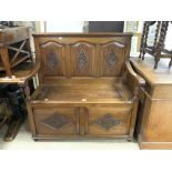 A SOLID CARVED PANELLED OAK MONKS BENCH, HALL SEAT WITH FIELDED PANELS, AND LIFT-UP SEAT