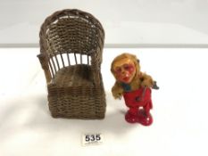 A VINTAGE MONKEY CLOCKWORK TOY AND A DOLL WICKER CHAIR