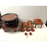 20TH CENTURY JAPANESE RED AND GOLD LACQUERED TRAYS, SMALL CABINET, SAUCERS, MINIATURE CABINET ETC