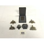 A 1926 SQUARE BRONZE PLAQUE FROM CZECH REPUBLIC IN BOX, AND SIX MILITARY CAP BADGES - VARIOUS