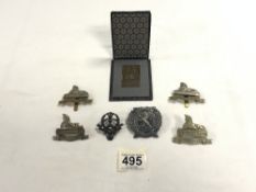 A 1926 SQUARE BRONZE PLAQUE FROM CZECH REPUBLIC IN BOX, AND SIX MILITARY CAP BADGES - VARIOUS