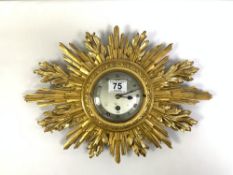 A SUNBURST WALL CLOCK BY ELLIOT