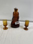 MID CENTURY BROWN GLASS EMBOSSED FACE AND ANIMAL DECORATED SYRUP BOTTLE 18.5CMS WITH TWO AMBER