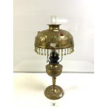 ART NOUVEAU EMBOSSED BRASS OIL LAMP, CONVERTED TO ELECTRIC, THE BRASS SHADE INSET WITH GLASS
