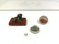 A MONTE-CARLO GLASS PAPERWEIGHT, CAITHNESS WANDERERA PAPERWEIGHT, AND A DOG BOOK PAPERWEIGHT