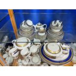 ROYAL PORCELAIN - GOLDEN VISTA SERIES, BLUE, GOLD, AND WHITE SEVENTY-PIECE DINNER SET