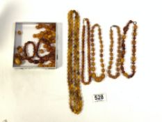 LARGE QUANTITY OF MAINLY BUTTERSCOTCH AMBER, 213 GRAMS IN TOTAL, ONE WITH YELLOW METAL CLASP