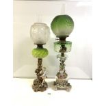 TWO CONTINENTAL PORCELAIN CONVERTED VICTORIAN OIL LAMPS WITH COLOURED GLASS FONTS, GREEN GLASS