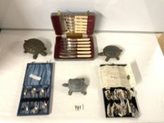 TWO CASED SETS OF PLATED SPOONS AND ONE FISH EATERS, WITH THREE INDIAN METAL TORTOISE POTS