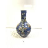 ANTIQUE CHINESE BLUE GROUND BOTTLE VASE, DECORATED WITH FLOWERS, FURNITURE, AND A VASE (A/F), 44CMS