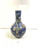 ANTIQUE CHINESE BLUE GROUND BOTTLE VASE, DECORATED WITH FLOWERS, FURNITURE, AND A VASE (A/F), 44CMS