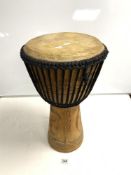 A CARVED WOODEN AFRICAN DRUM