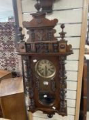 VICTORIAN WALNUT VIENNA WALL CLOCK WITH BRASS DIAL AND TURNED SUPPORT DECORATION