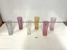 A SET OF SIX COLOURED GLASS, CLOWN DECORATED LONG GLASSES (18CMS)