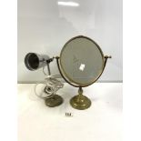 1960S ALUMINUM TABLE LAMP ON AN IRON BASE, WITH AN OVAL BRASS SWING FRAME VANITY MIRROR