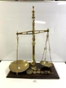 A LARGE SET OF VICTORIAN BRASS BALANCE SCALES AND SOME WEIGHTS ON A WOODEN BASE - MADE BY WINSBURY &