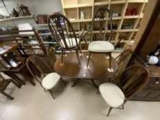 ERCOL GOLD STAMP OVAL EXTENDING DINING TABLE WITH SIX MATCHING HOOP SWAN BACK DINING CHAIRS, TABLE