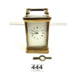 A BRASS CARRIAGE CLOCK TIMEPIECE BY HENLEY CLOCK COMPANY WITH KEY