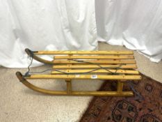 A WOODEN SLEDGE, DAVOS MADE IN AUSTRIA.