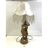 GOLD-PAINTED PLASTER CHERUB FIGURE TABLE LAMP WITH A BEADED SHADE 64 CM