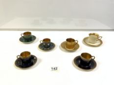 FIVE ROSENTHAL DECORATIVE COFFEE CANS AND SAUCERS AND A THOMAS/BRAVAVIA GOLD-DECORATED COFFEE CAN