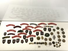 A QUANTITY MILITARY BADGES AND CLOTH SEW ON PATCHES AND A MEDAL BAR.