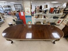 A LARGE CHIPPENDALE-STYLE MAHOGANY OVAL EXTENDING DINING TABLE, WITH TWO EXTRA LEAVES, ON BALL AND