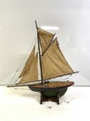 A VINTAGE GREEN AND BLACK PAINTED POND YACHT WITH SAILS 38 CM