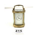 SMALL OVAL BRASS CARRIAGE CLOCK WITH WHITE ENAMEL DIAL, 9CM