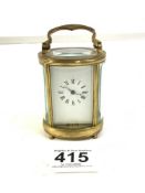 SMALL OVAL BRASS CARRIAGE CLOCK WITH WHITE ENAMEL DIAL, 9CM