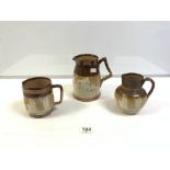 TWO DOULTON LAMBETH GLAZED STONEWARE VICTORIA 1887 JUBILEE JUGS WITH A SIMILAR LARGER DOULTON