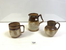 TWO DOULTON LAMBETH GLAZED STONEWARE VICTORIA 1887 JUBILEE JUGS WITH A SIMILAR LARGER DOULTON