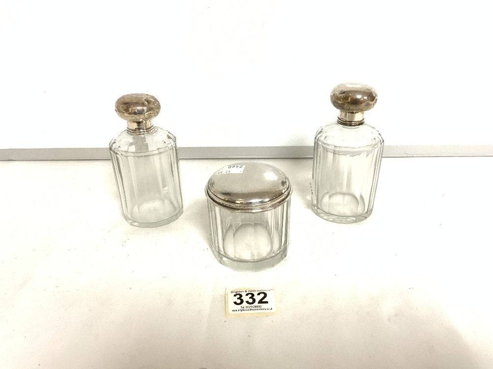 THREE TOILET BOTTLES WITH CONTINENTAL WHITE METAL TOPS.