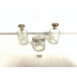 THREE TOILET BOTTLES WITH CONTINENTAL WHITE METAL TOPS.