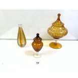 AMBER GLASS FOOTED BOWL AND COVER 24CM WITH A SMALLER JAR AND COVER AND AN AMBER GLASS DECANTER